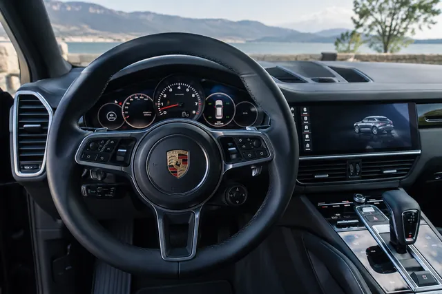 Porsche Cayenne instrument cluster with a tire pressure display and steering wheel controls