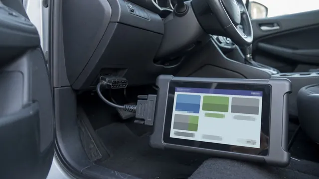 OBD-II scanner plugged into a car's diagnostic port, reading a stored trouble code