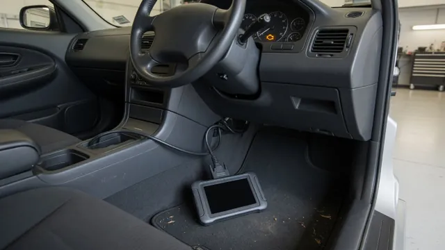 Diagnostic scanner connected inside a parked vehicle during a check-engine light inspection