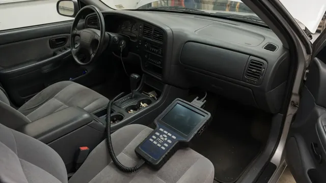 Diagnostic scanner beside a parked vehicle during a P1570 code assessment