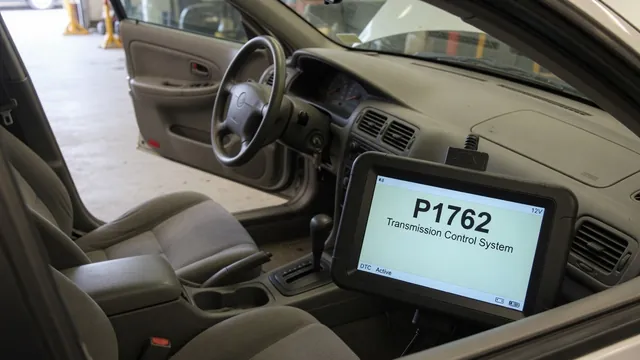 Diagnostic scanner beside a vehicle dashboard displaying the trouble code P1762