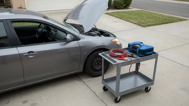 Car with its hood open, jumper cables and a portable jump pack nearby during a no-start assessment