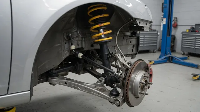 Car suspension showing bushings, a ball joint, a strut, and a sway bar link