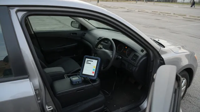 Vehicle dashboard with an illuminated check engine light and a diagnostic scanner displaying P2176