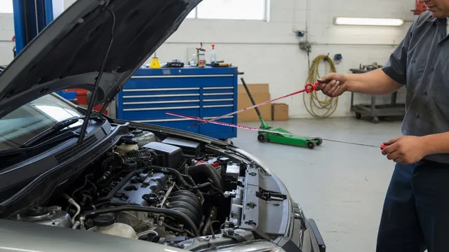 Automatic transmission fluid dipstick being inspected beside an open engine bay