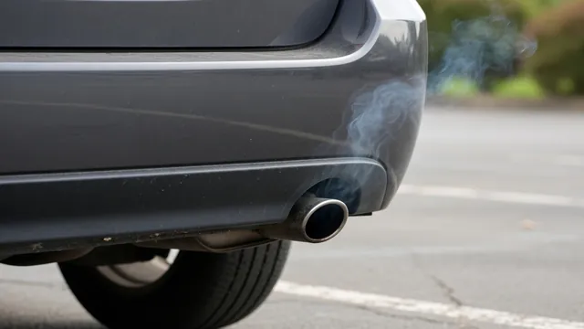 A faint blue-gray plume emerging from a parked car’s exhaust pipe outdoors