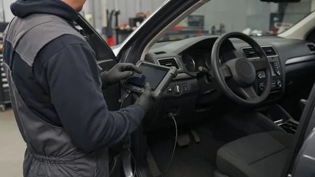 Technician reviewing chassis fault information on a scan tool beside a parked vehicle