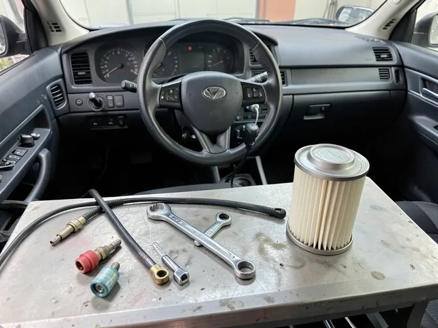 Fuel line disconnect tools, a line wrench, and a canister filter wrench arranged beside a fuel filter