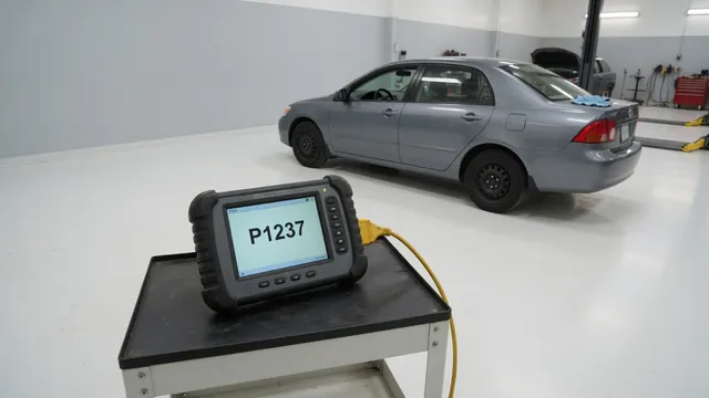 Diagnostic scanner displaying P1237 beside a vehicle in a repair shop