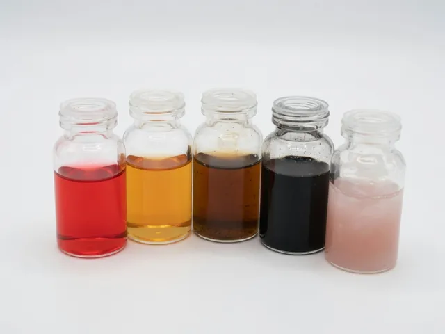 Transmission fluid color chart showing red, amber, brown, black, and cloudy pink samples
