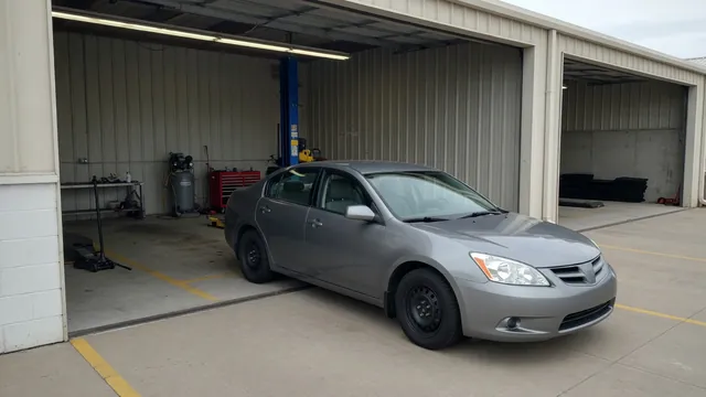 Nissan Maxima parked at an automotive service bay for a CVT inspection
