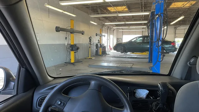 Slightly off-center steering wheel inside a parked car at an alignment shop