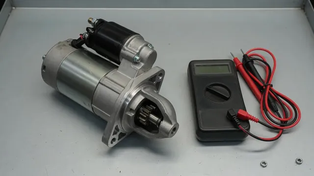 Starter motor beside a multimeter on a clean automotive workshop bench