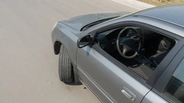 Parked car with its front tire tread and steering wheel visible during an alignment symptom inspection