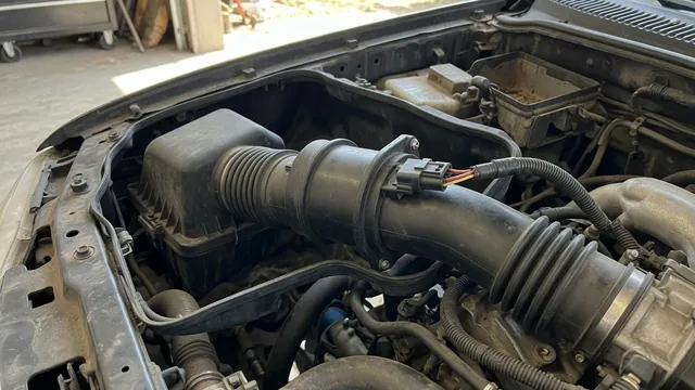 Mass air flow sensor in the intake tube between the air filter box and throttle body on a compact pickup truck