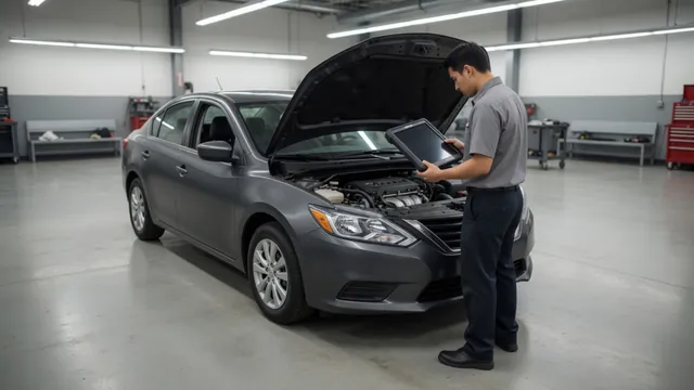 Technician reviewing a diagnostic scan tool beside a parked vehicle with its hood open
