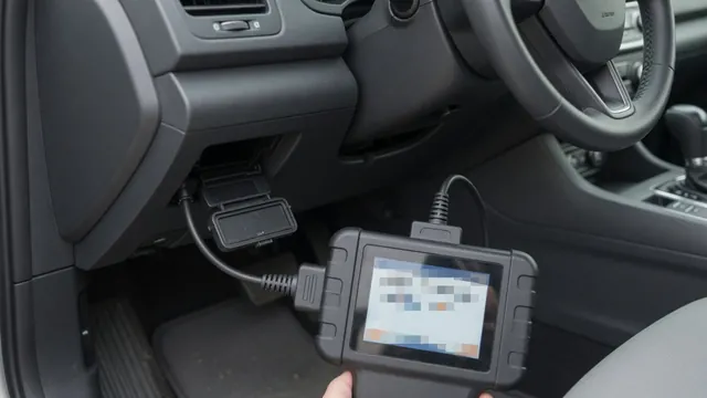 OBD-II scan tool plugged into a car's diagnostic port and showing a trouble code reading