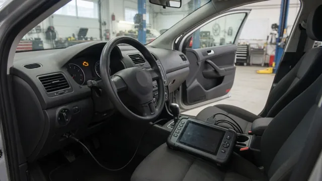 Diagnostic scanner connected inside a parked vehicle during a check engine light inspection