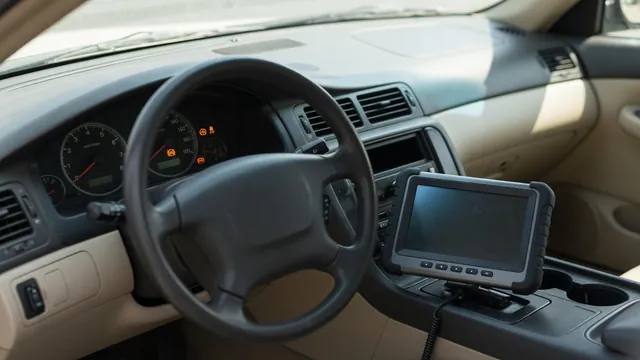 Dashboard with illuminated ABS and traction control warning lights and a diagnostic scanner nearby
