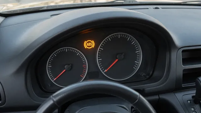 Amber ABS warning light illuminated on a vehicle dashboard while parked