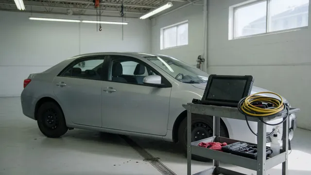 Diagnostic scanner beside a parked vehicle with the engine off
