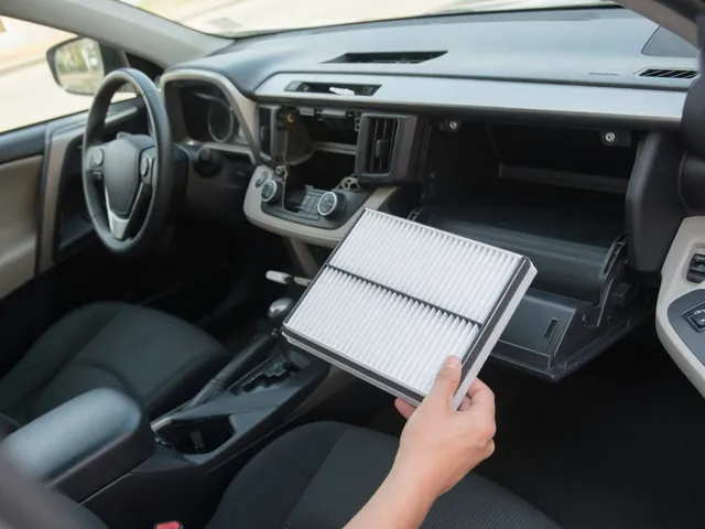 Cabin air filter beside an open Toyota RAV4 glove compartment, ready for installation